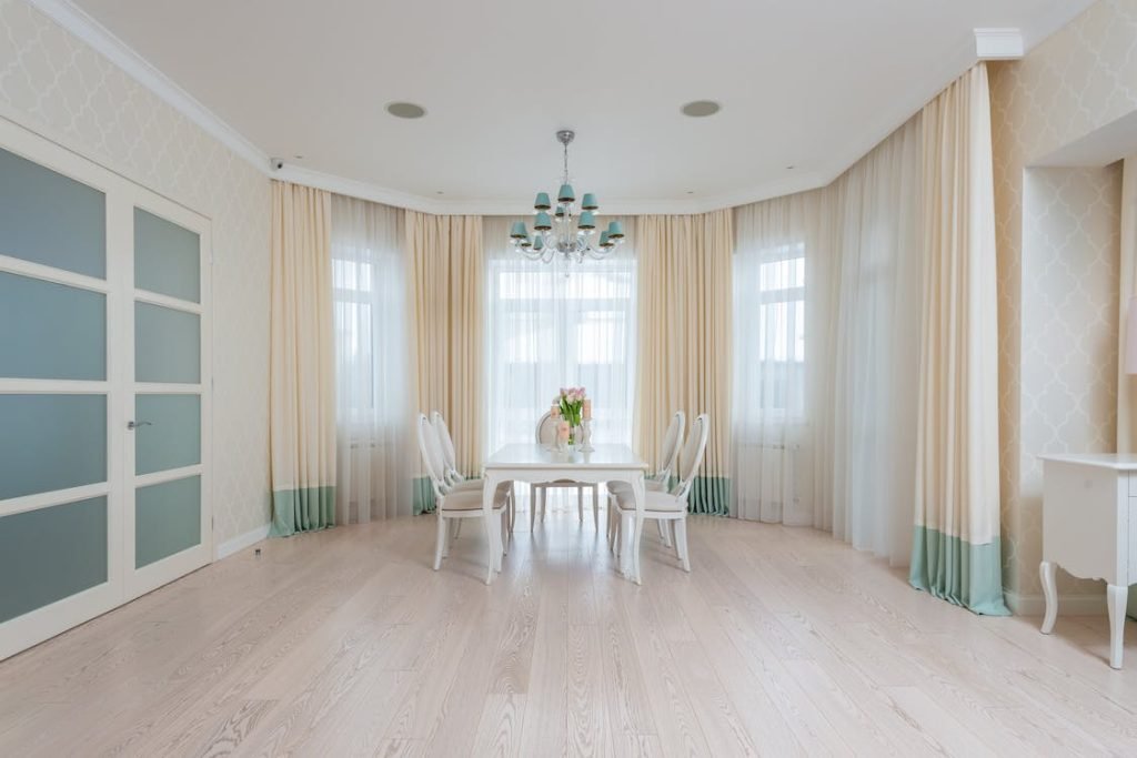 How to choose curtains for your living room: Cream and aqua curtains.