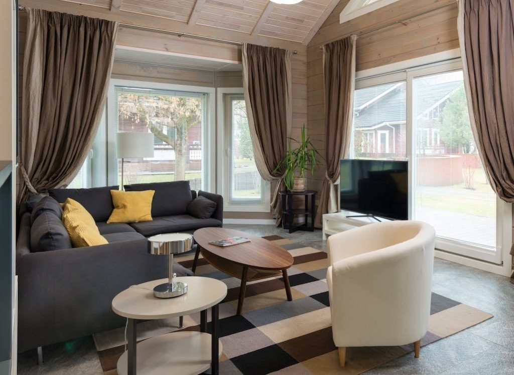 How to choose curtains for your living room: Living room with grey sofa and brown curtains.